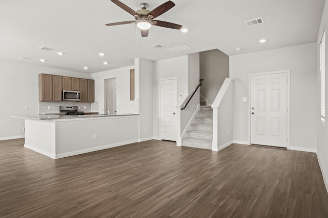 2321 Mooneye Ct, Conroe, TX 77384 - unfurnished living room with ceiling fan, sink, and dark hardwood / wood-style floors