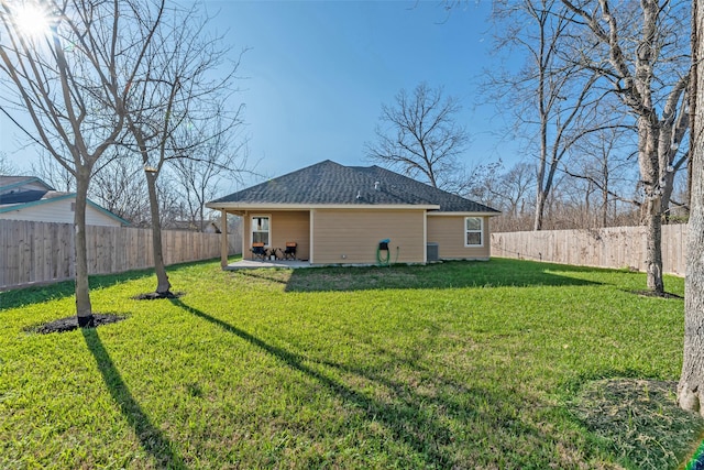 rear view of property with central air condition unit, a patio area, and a lawn