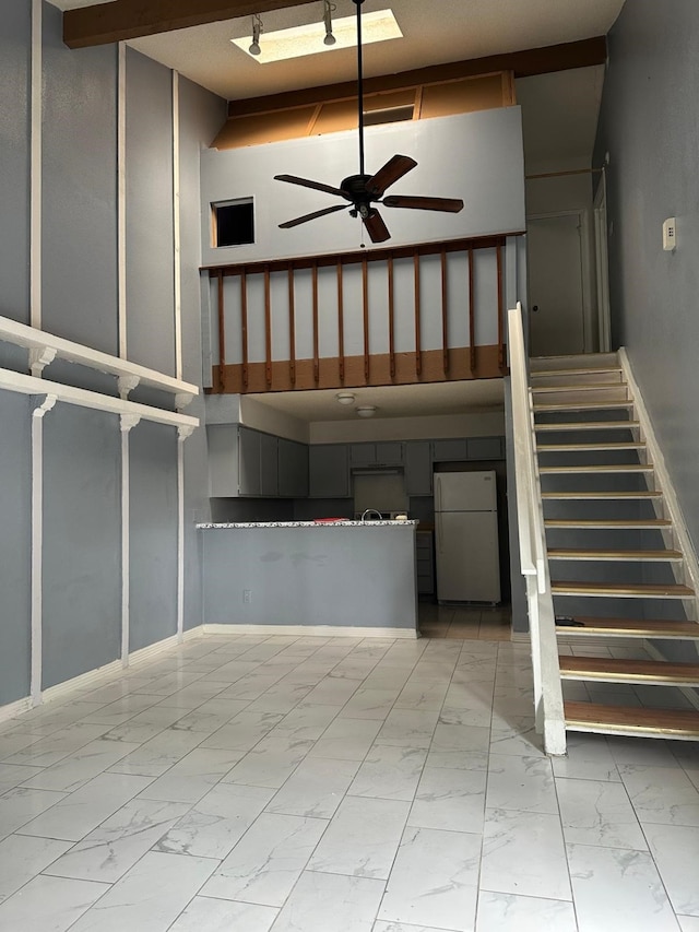 stairway with ceiling fan