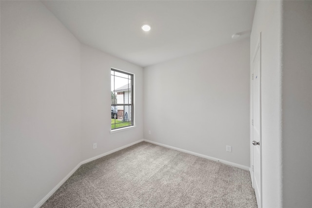 spare room featuring light colored carpet