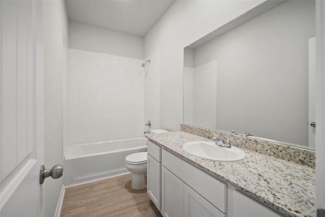 full bathroom featuring hardwood / wood-style floors, vanity, shower / bath combination, and toilet