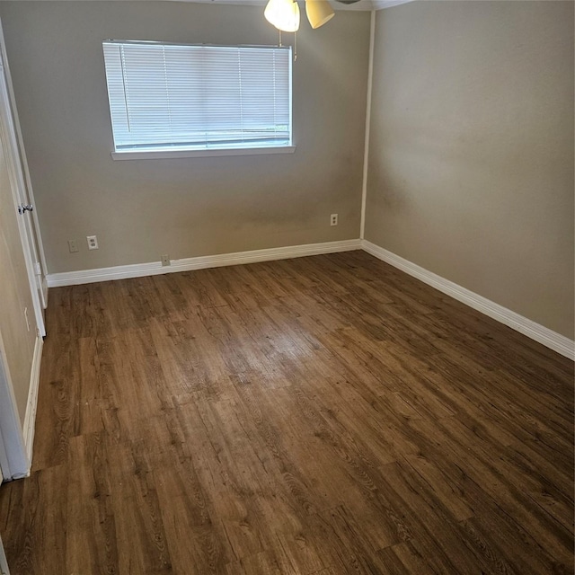 spare room featuring ceiling fan, dark hardwood / wood-style flooring, and plenty of natural light