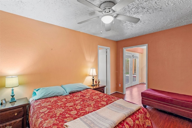 bedroom with wood-type flooring, a textured ceiling, access to outside, and ceiling fan