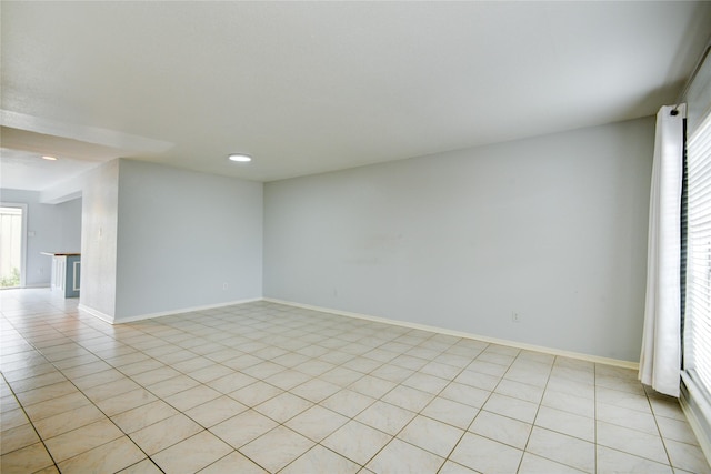 unfurnished room featuring light tile patterned floors and plenty of natural light