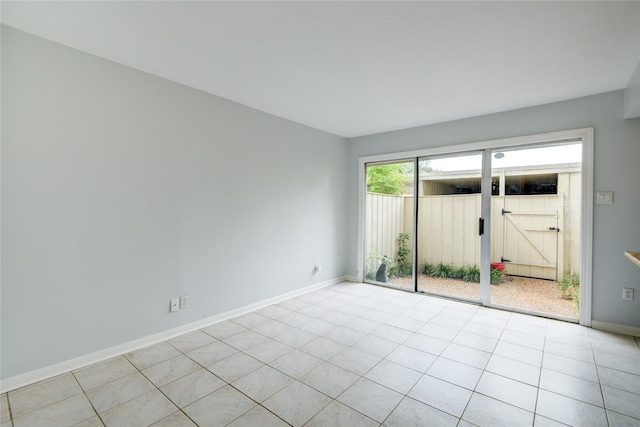 spare room featuring light tile patterned floors