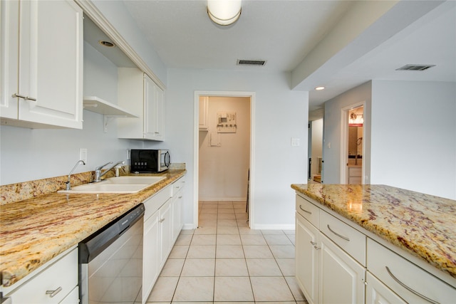 kitchen featuring appliances with stainless steel finishes, light stone counters, white cabinetry, and sink