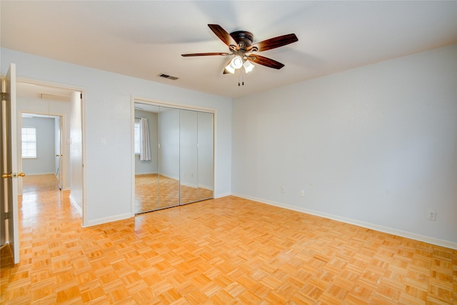 unfurnished bedroom featuring ceiling fan and light parquet flooring