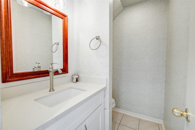 bathroom with tile patterned flooring, vanity, and toilet