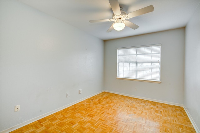 unfurnished room with ceiling fan and light parquet flooring