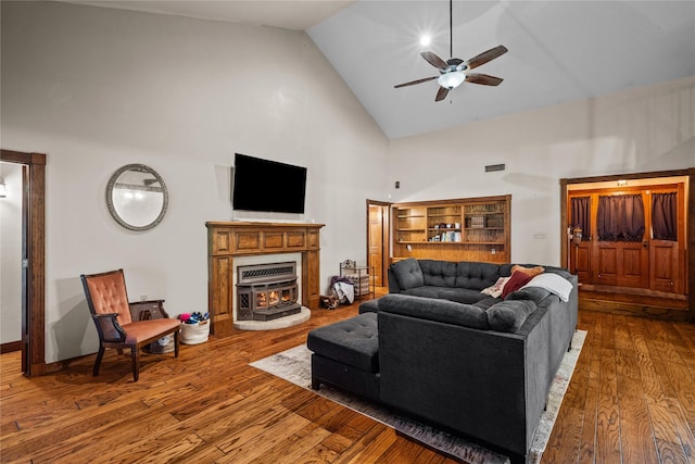 living room featuring ceiling fan, hardwood / wood-style floors, and high vaulted ceiling