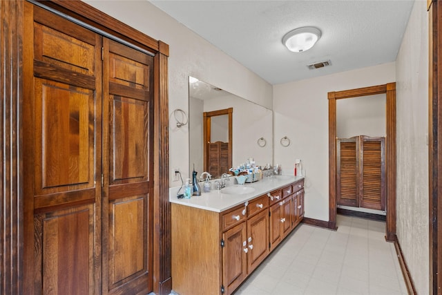 bathroom with vanity and a textured ceiling