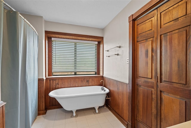 bathroom featuring wood walls and independent shower and bath