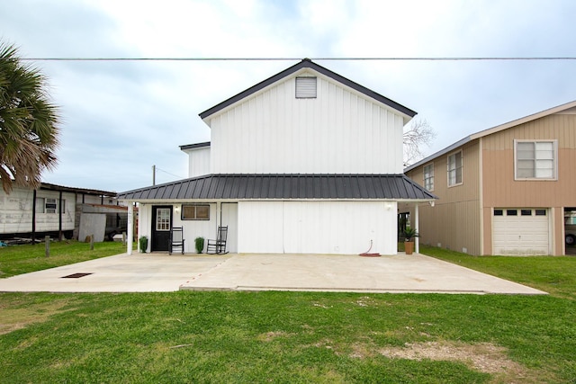 back of property with a porch and a yard