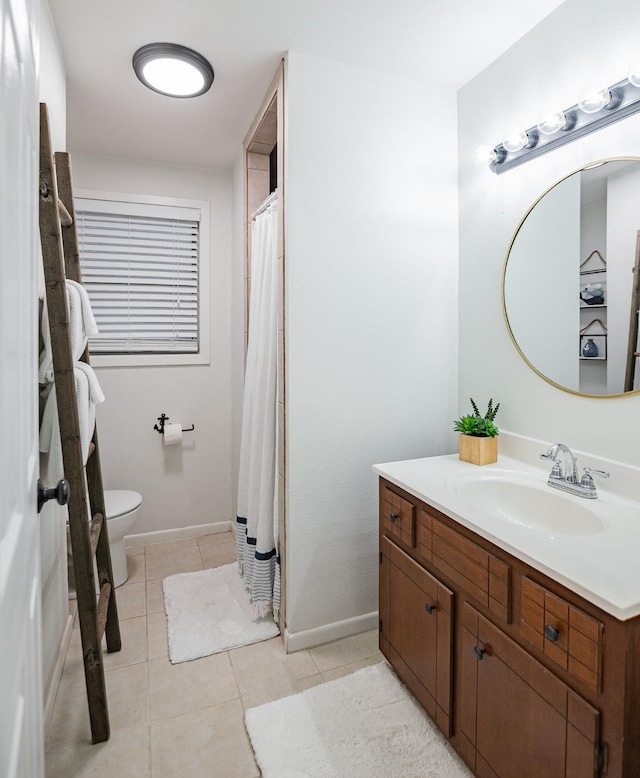 bathroom featuring tile patterned flooring, vanity, and toilet