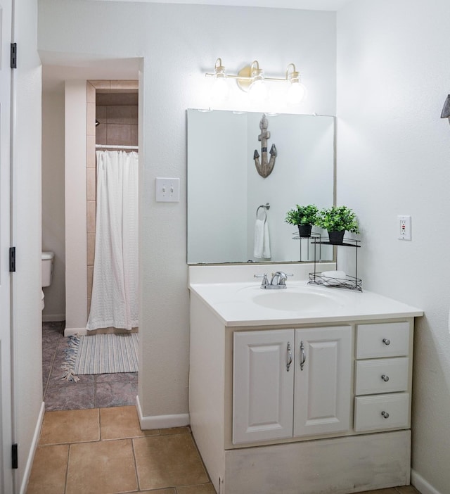 bathroom featuring tile patterned flooring, vanity, a shower with shower curtain, and toilet