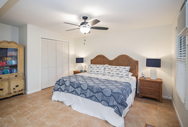 bedroom featuring ceiling fan, a closet, and light tile patterned floors