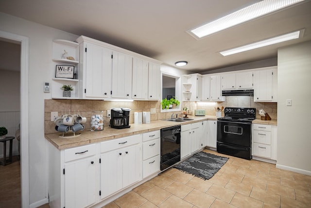 kitchen featuring white cabinets, vaulted ceiling, decorative backsplash, light tile patterned floors, and black appliances