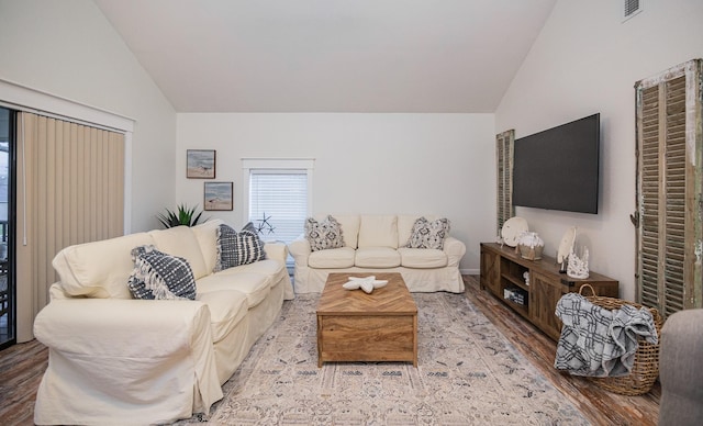 living room with light hardwood / wood-style flooring and vaulted ceiling