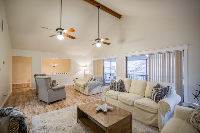 living room with high vaulted ceiling, beamed ceiling, a chandelier, and hardwood / wood-style flooring