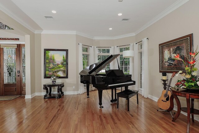 miscellaneous room featuring light wood-type flooring and ornamental molding