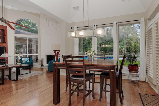 dining area featuring hardwood / wood-style flooring, plenty of natural light, ceiling fan, and lofted ceiling