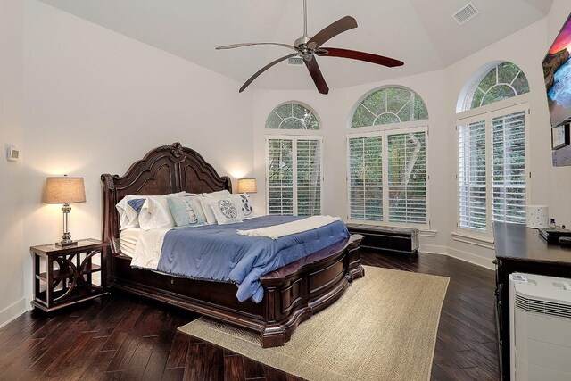 bedroom with vaulted ceiling, ceiling fan, and dark wood-type flooring