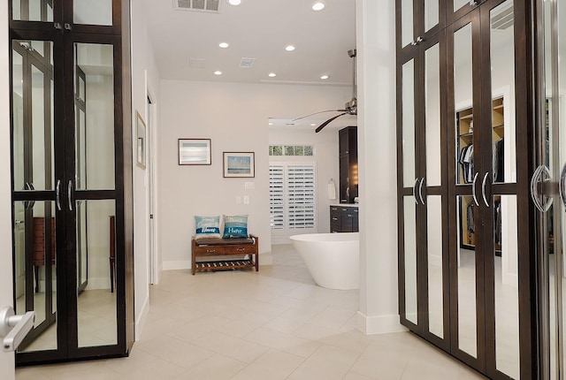 hall featuring light tile patterned floors