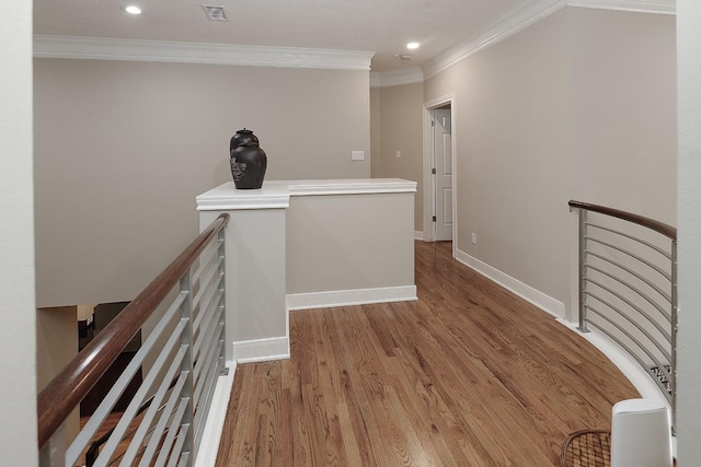 hallway with wood-type flooring and crown molding