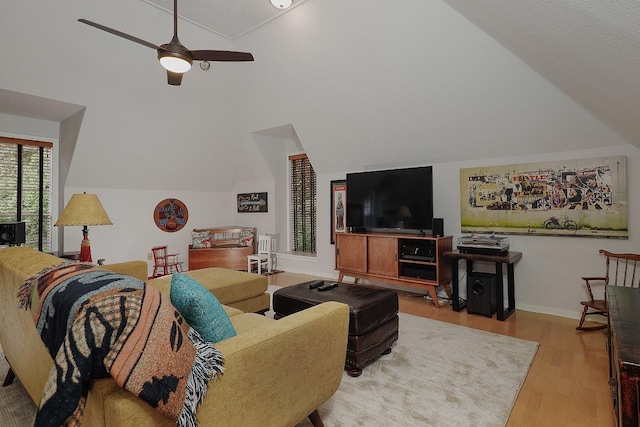 living room with light wood-type flooring, vaulted ceiling, and ceiling fan