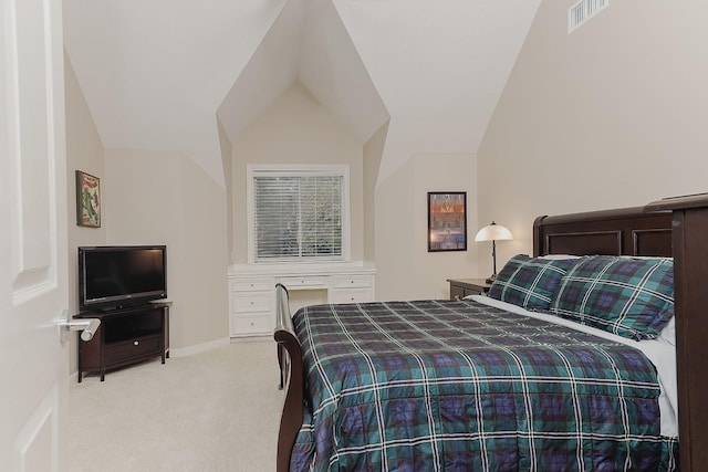 bedroom with light colored carpet and vaulted ceiling