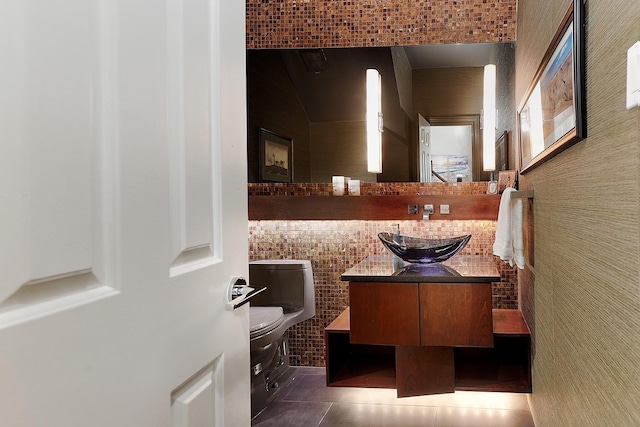 bathroom featuring tile patterned flooring, vanity, and toilet