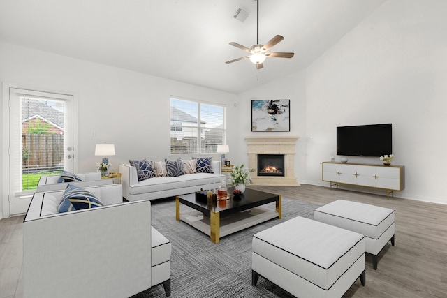 living room with hardwood / wood-style floors, ceiling fan, and a wealth of natural light