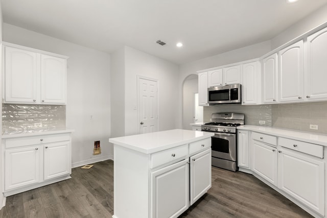 kitchen with a center island, white cabinetry, appliances with stainless steel finishes, and tasteful backsplash