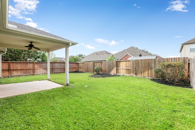 view of yard with ceiling fan and a patio