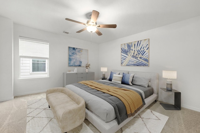 bedroom featuring ceiling fan and light carpet