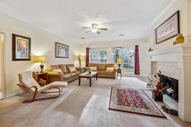 carpeted living room with a textured ceiling, ceiling fan, crown molding, and a fireplace