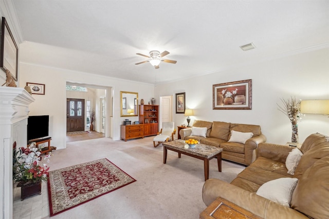 carpeted living room featuring ceiling fan and ornamental molding