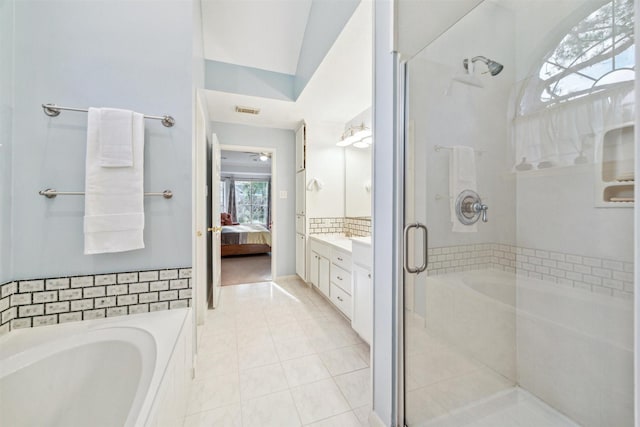 bathroom with tile patterned floors, vanity, independent shower and bath, and lofted ceiling