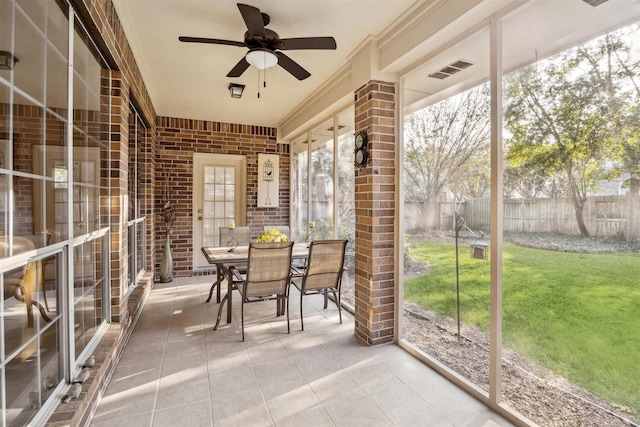 unfurnished sunroom with ceiling fan