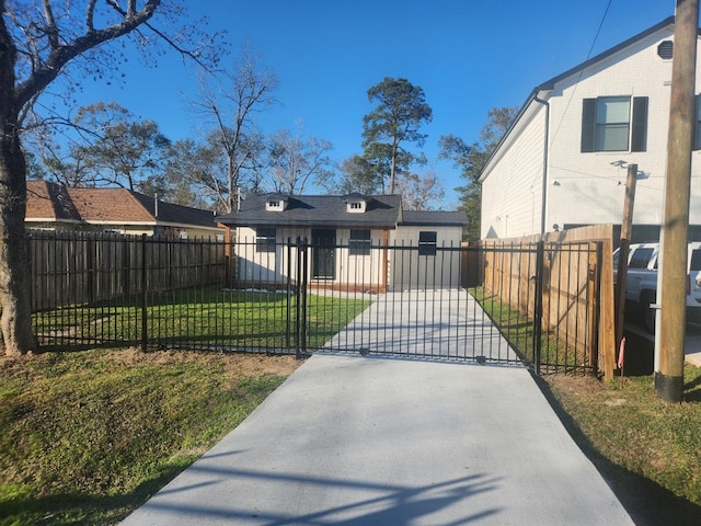 view of gate with a lawn