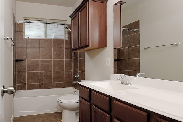 full bathroom featuring tile patterned flooring, tiled shower / bath combo, toilet, and vanity