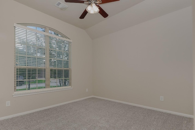 carpeted empty room featuring ceiling fan and lofted ceiling