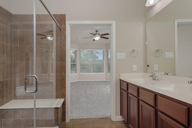 bathroom with tile patterned flooring, vanity, ceiling fan, and walk in shower