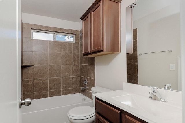 full bathroom with vanity, tiled shower / bath combo, and toilet