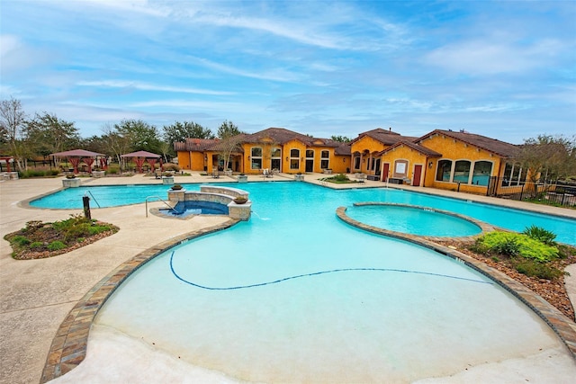 view of pool with a gazebo and a hot tub