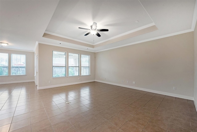 tiled empty room with a tray ceiling, ceiling fan, and crown molding