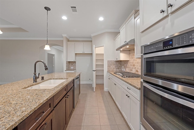 kitchen featuring sink, ornamental molding, decorative light fixtures, white cabinetry, and stainless steel appliances