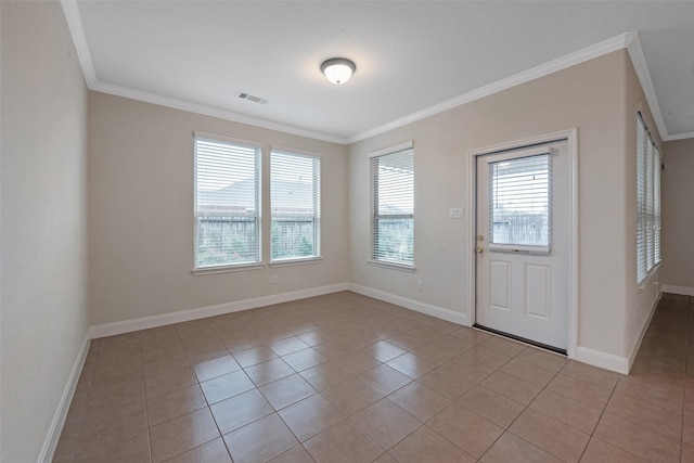 entrance foyer with crown molding and light tile patterned floors