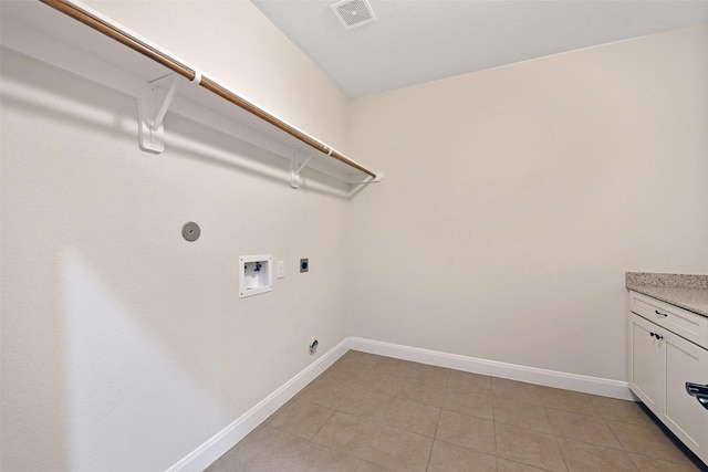 clothes washing area with hookup for an electric dryer, hookup for a washing machine, and light tile patterned floors