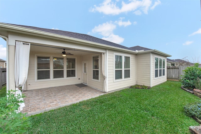 back of house with ceiling fan, a patio area, and a yard